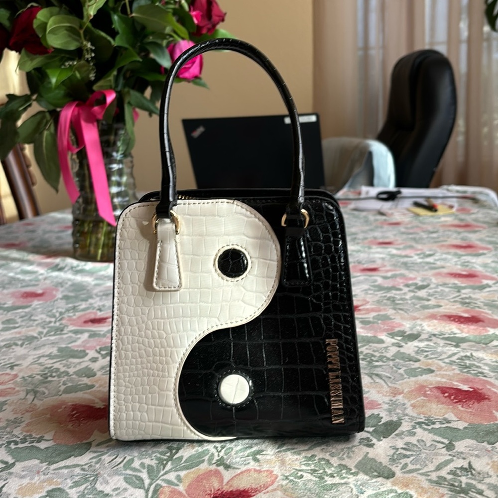 A used Poppy Lissiman YingYang mini hand bag.